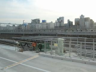 東海道線下り列車から見た新車両基地北側の留置線。画面中央は高輪橋架道橋と交差しており、拡幅に対応した長さの桁になっている。